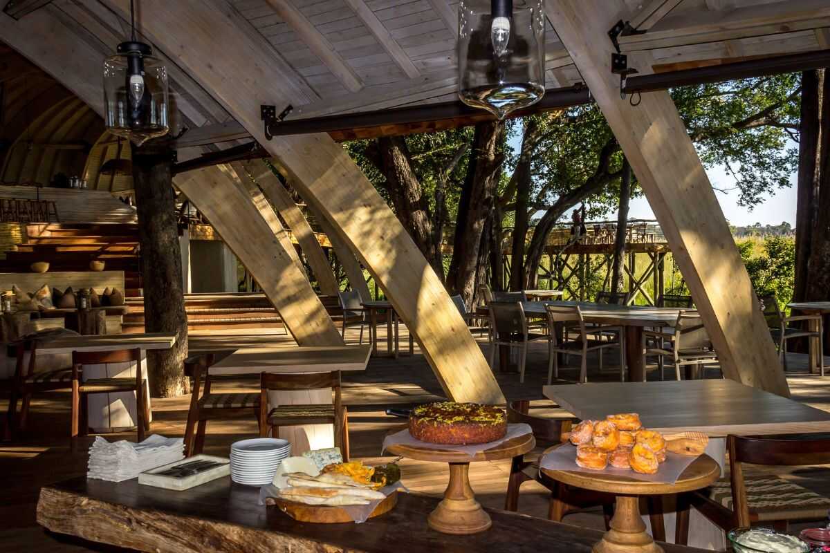 Solar-powered safari lodge in Botswana with elephants nearby, showcasing low-impact travel and green accommodations in Africa