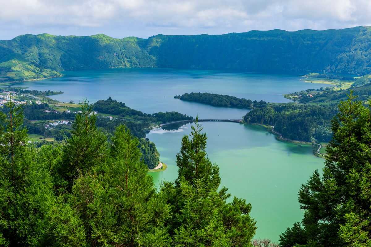 Aerial view of Sete Cidades twin crater lakes in the Azores, showcasing lush green volcanic landscapes and sustainable eco-tourism
