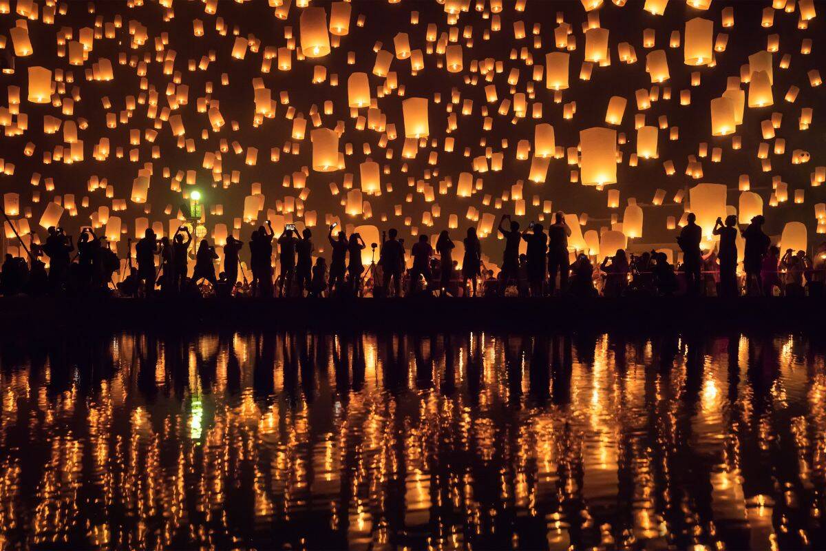 Thousands of paper lanterns released into the sky during Yi Peng and Loy Krathong celebrations in Chiang Mai