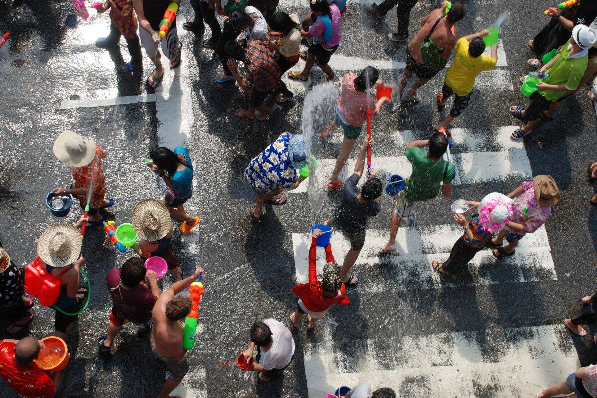 Tourists and locals enjoying Songkran water fight on Khao San Road, Bangkok during Thailand's New Year Festival 2025